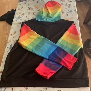 Black pullover hooded shirt with rainbow sleeves and hood.